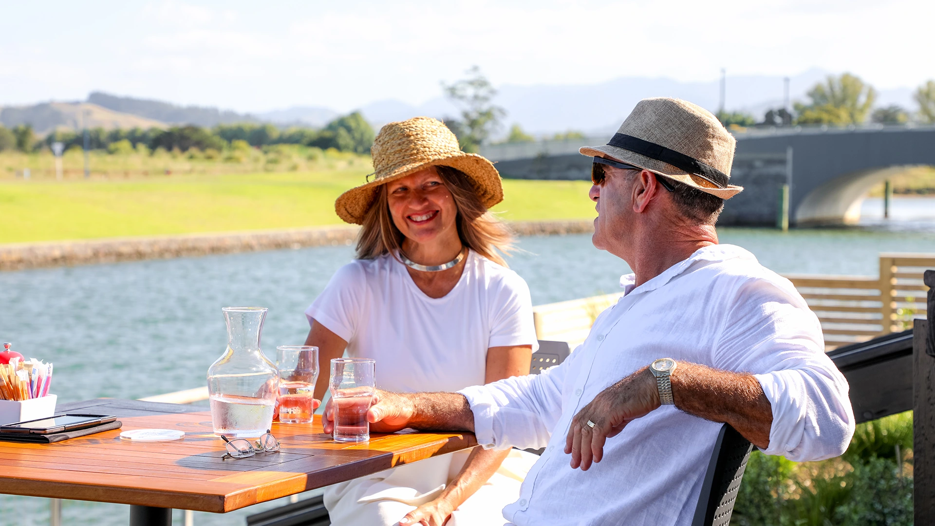 Couple enjoying a drink at a waterfront cafe