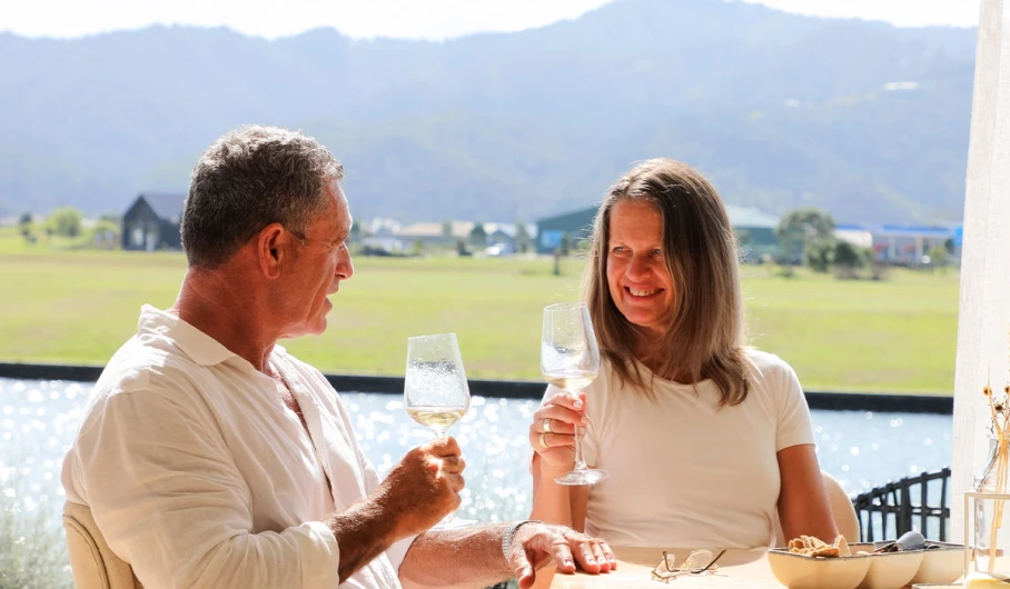 Mature couple enjoying a glass of wine together in the sun